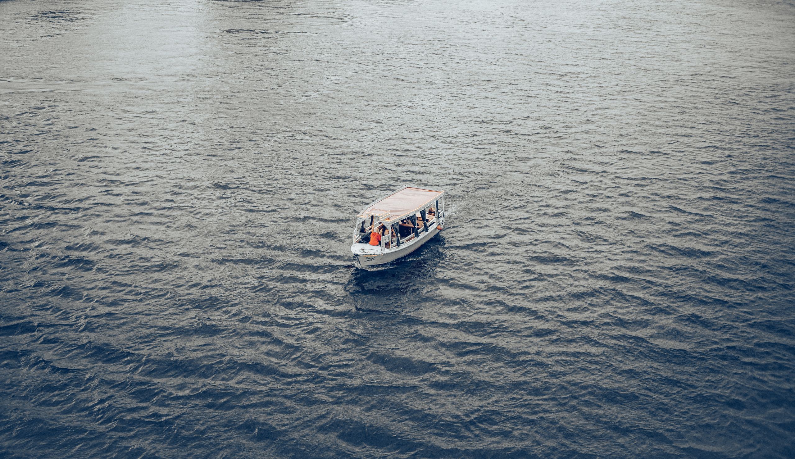 A motorboat sails on the Nile River in Cairo, providing a tranquil scene.