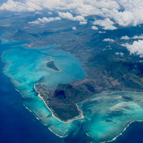 Stunning aerial view of Mauritius with vibrant turquoise waters and lush landscapes.